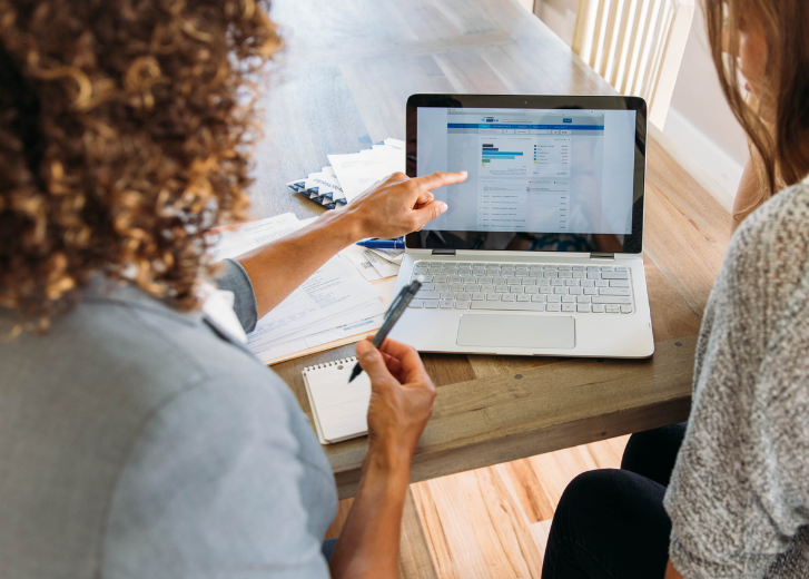 woman working on computer with client
